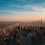 a group of people standing on top of a tall building