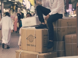 man sitting on boxes outdoors