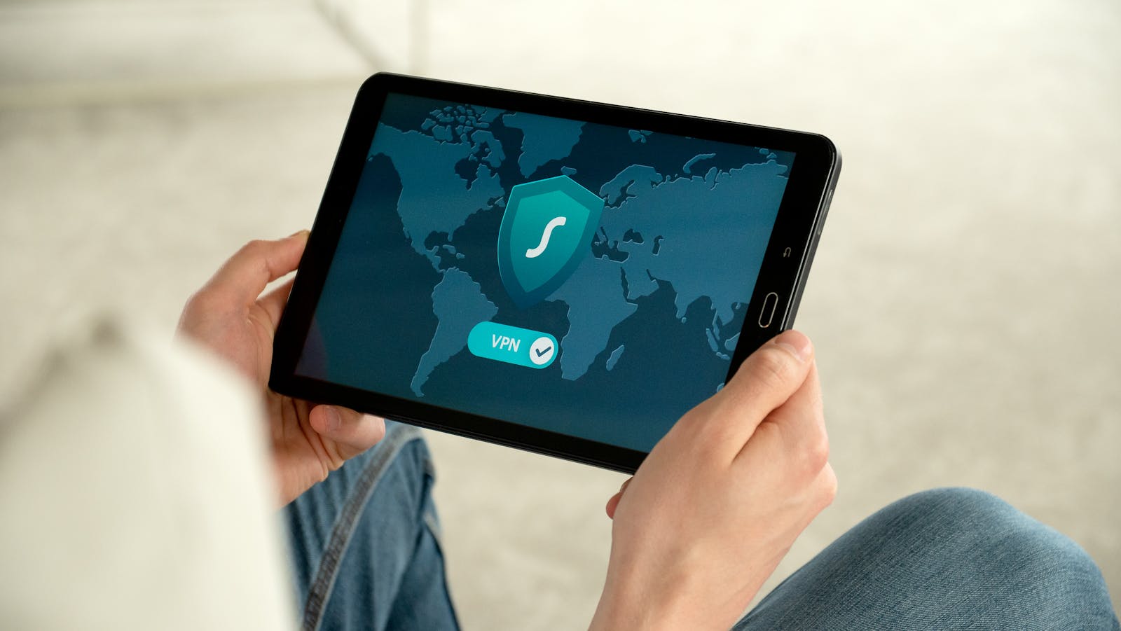 Cyber Security, Privacy and Data Protection (CSPDP) and Transformation, Automation, and Outsourcing (TAO) services. Person holding tablet with VPN connection screen for secure internet browsing.