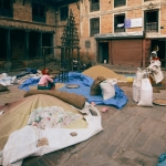 Scene of people working with grain bags in a traditional brick courtyard.