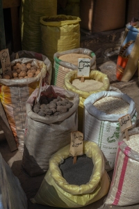 Colorful sacks filled with grains and spices at a Baghdad market, showcasing local trade and culture.