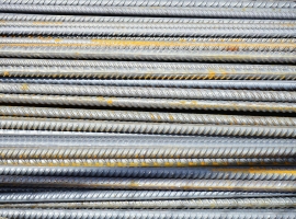 Close-up of stacked rusty steel reinforcing bars used in construction.