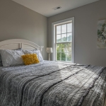 Comprehensive Guide on Real Estate Business in Nigeria A warm, inviting bedroom with a double bed and natural light streaming in.