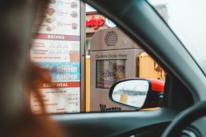 A customer interacts with a drive-thru menu to order fast food conveniently from their car.