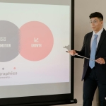 Confident businessman presenting infographics on promotion and growth during a meeting.